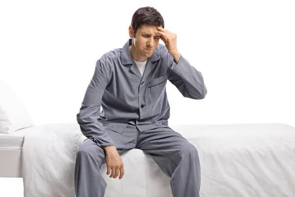 Young Man Pajamas Sitting Bed Suffering Headache Isolated White Background — Stock Photo, Image