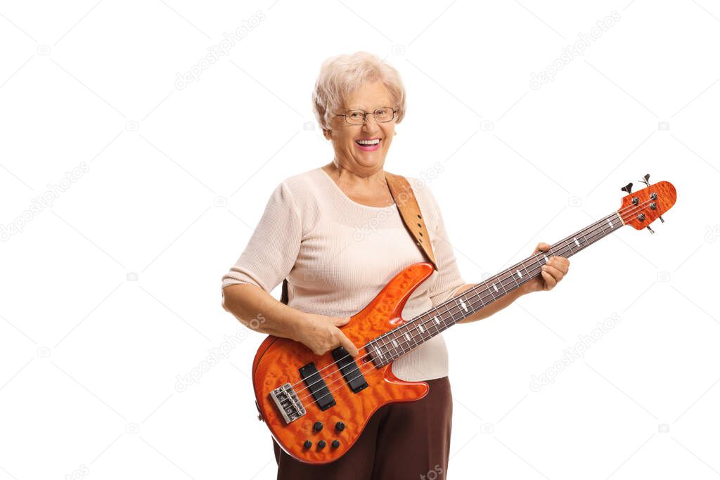 Elderly woman with an electric bass guitar smiling at the camera isolated on white background