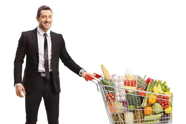 Jovem Empresário Posando Com Carrinho Compras Com Comida Isolada Fundo — Fotografia de Stock