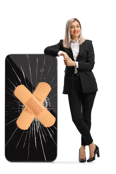 Full Length Portrait Businesswoman Leaning Broekn Smartphone Adhesive Bandage Isolated — Stock Photo, Image