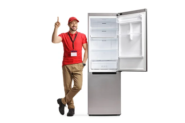 Male Shop Assistant Leaning Fridge Pointing Isolated White Background — Stock Photo, Image