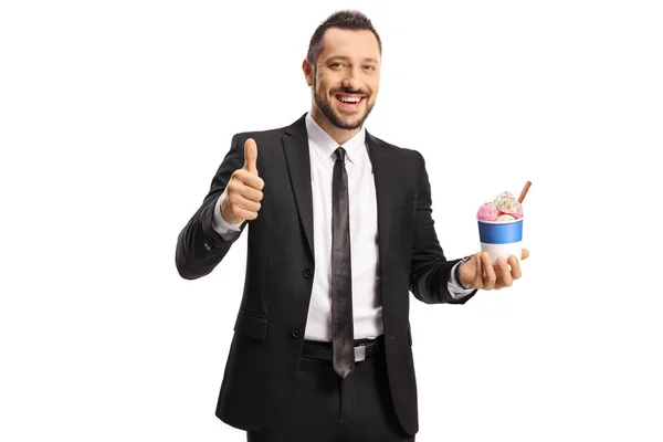 白い背景に隔離された親指を示す紙コップにアイスクリームを持つビジネスマン — ストック写真