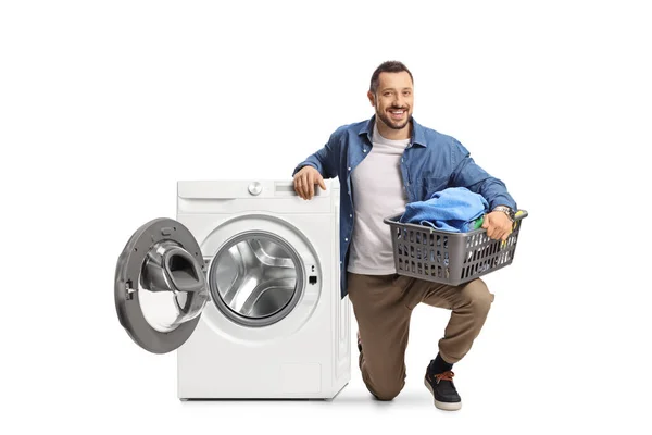 Young Man Kneeling Nesto Washing Machine Holding Loundry Basket Isolated — Stock Photo, Image