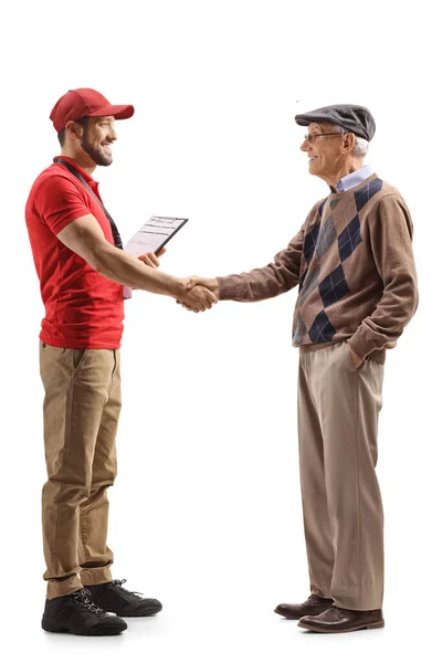 Full Length Profile Shot Delivery Man Shaking Hands Pensioner Isolated — Stock Photo, Image