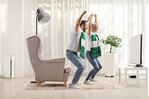 Young Couple Home Watching Sports Match Cheering Scarfs — Stock Photo, Image