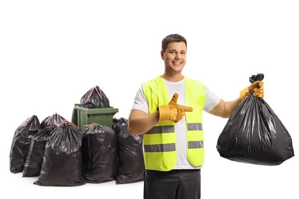 Garbageman Håller Plastpåse Framför Bin Och Hög Med Påsar Och — Stockfoto