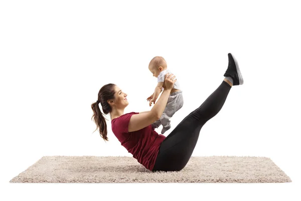 Madre Esercitando Abs Tenendo Suo Bambino Isolato Sfondo Bianco — Foto Stock