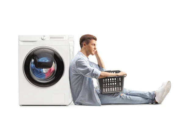 Casual Guy Sitting Waiting Laundry Basket Next Washing Machine Isolated — Stock Photo, Image