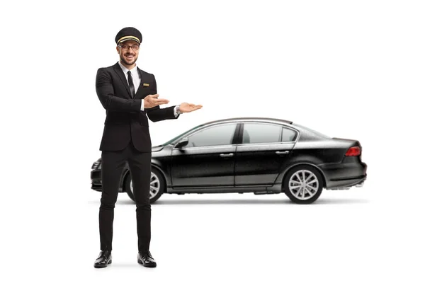 Full Length Portrait Professional Chauffeur Pointing Black Car Isolated White — Stockfoto