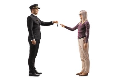 Chauffeur giving car keys to a young blond woman isolated on white background