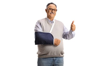 Mature man with an arm splint smiling at camera and gesturing a thumb up sign isolated on white background