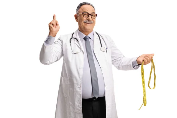 Mature Male Doctor Holding Measuring Tape Pointing Isolated White Background — Stock Photo, Image