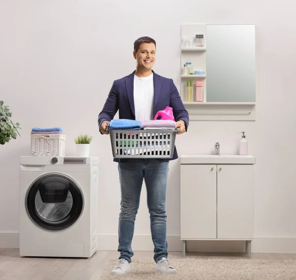 Full Length Portrait Young Man Holding Laundry Basket Clothes Bathroom — Stock Photo, Image