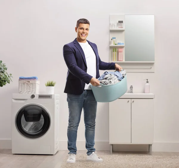 Full Length Portrait Handsome Man Holding Laundry Basket Bathroom — Stock Photo, Image