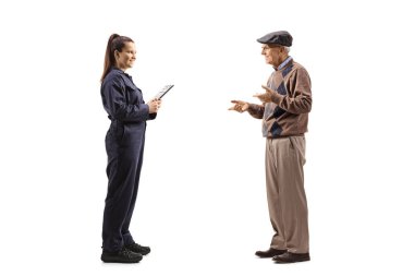 Full length profile shot of a young female auto mechanic having a conversation with an elderly man isolated on white background