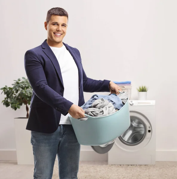 Smiling Young Man Holding Laundry Basket Bathroom Home — Stockfoto