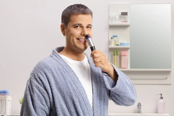 Young Man Using Nose Trimmer Bathroom Smiling Camera — Foto Stock