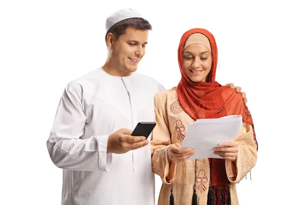 Young Man Woman Ethnic Clothes Holding Paper Using Mobile Phone —  Fotos de Stock