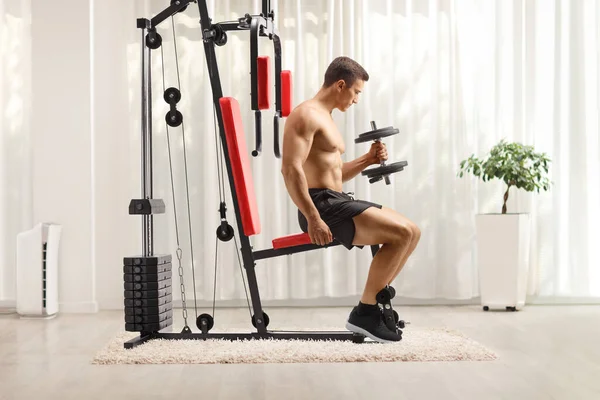 Young Guy Bodybuilder Shirtless Sitting Exercising Fitness Machine Indoors — Stock Photo, Image