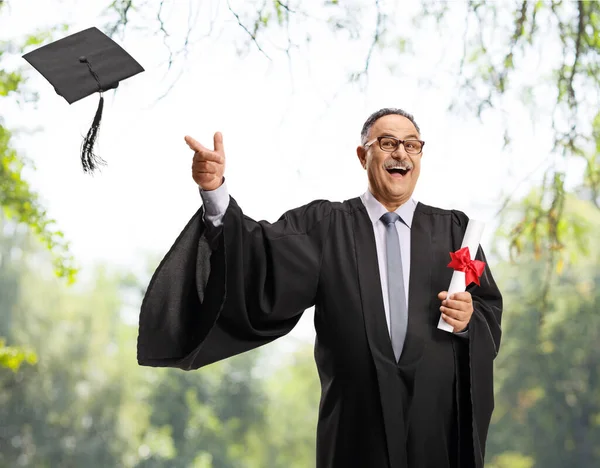 Mature Man Graduation Gown Holding Diploma Throwing His Hat Park — Stock Photo, Image