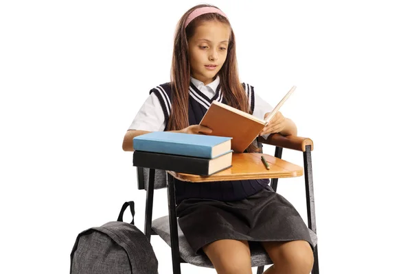 Schoolmeisje Zitten Een Schoolstoel Het Lezen Van Een Boek Geïsoleerd — Stockfoto