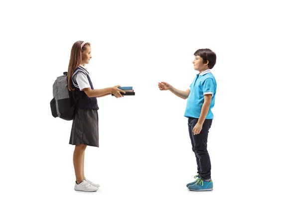 Schoolgirl Giving Books Young Boy Isolated White Background — Stock Photo, Image