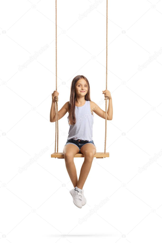 Smiling female child with long hair sitting on a wooden swing isolated on white background