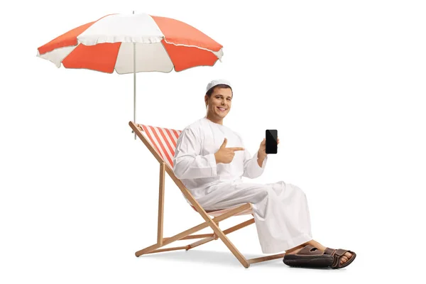 Young Man Ethnic Clothes Sitting Umbrella Pointing Mobile Phone Isolated — Stock Photo, Image