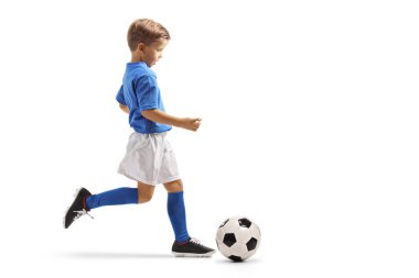 Beyaz arka planda, futbol topuyla koşan bir çocuğun tam boy profil çekimi.