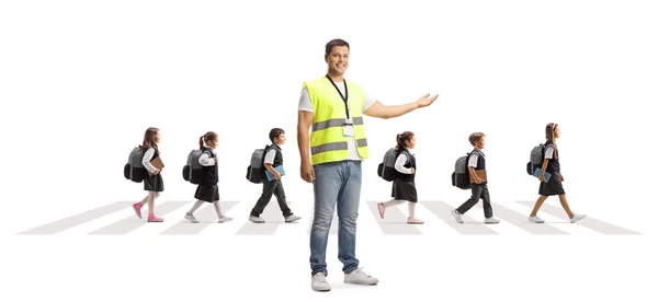 Community Worker Vest Pointing Schoolchildren Walking Zebra Crossing Isolated White — Stock Photo, Image