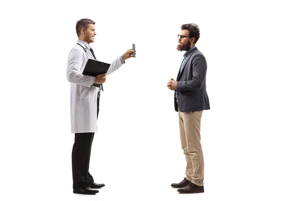 Young Male Doctor Showing Results Mobile Phone Patient Isolated White — Stock Photo, Image