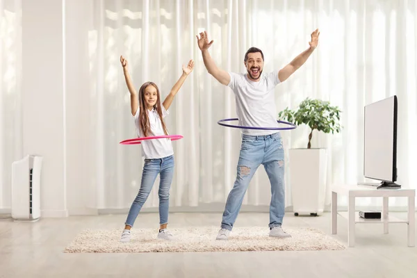 Cheerful Father Daughter Spinning Hula Hoops Home — Stock Photo, Image