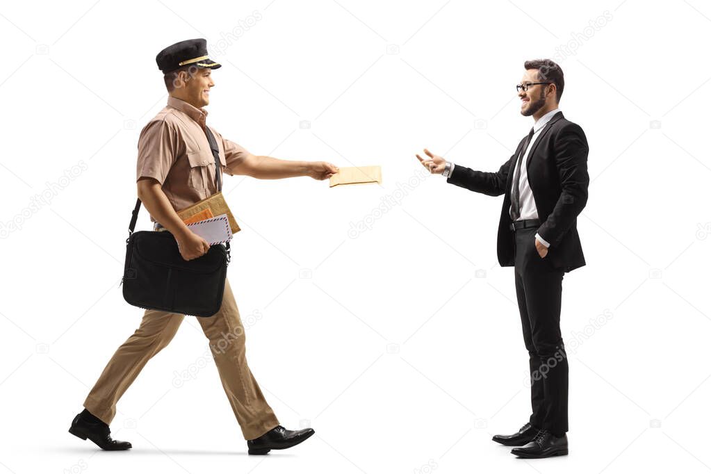 Full length profile shot of a mailman giving a letter to a businessman isolated on white background