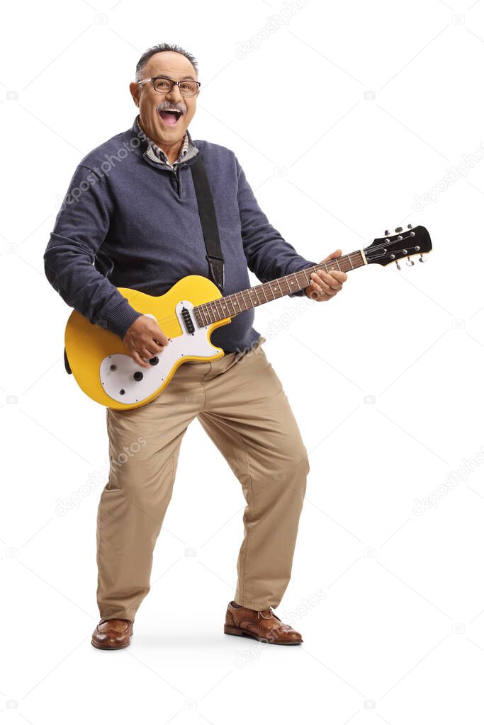 Full length portrait of a cheerful energetic mature man playing a guitar isolated on white background