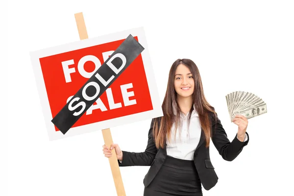 Realtor holding sign and money — Stock Photo, Image