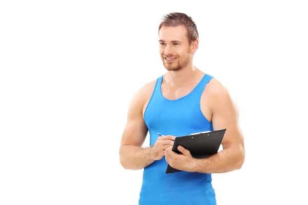 Fitness coach holding clipboard — Stock Photo, Image