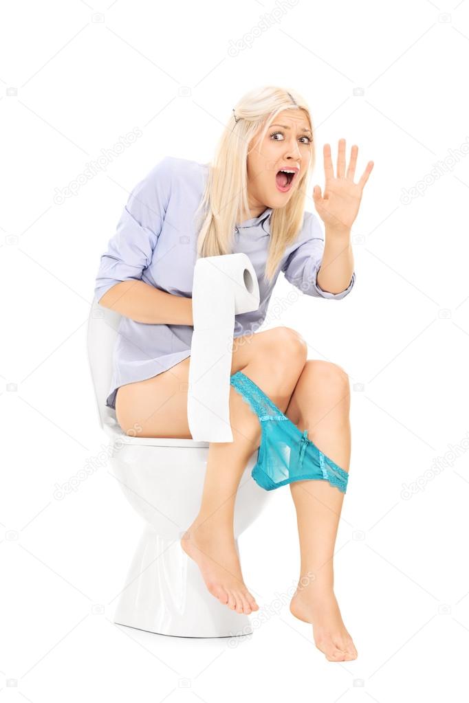 Interrupted girl sitting on toilet
