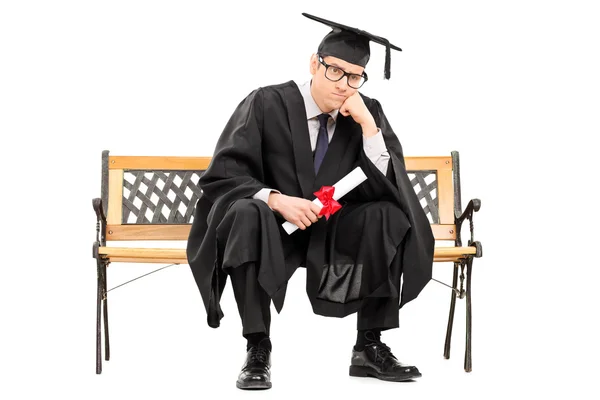 Enojado universidad graduado sosteniendo diploma — Foto de Stock