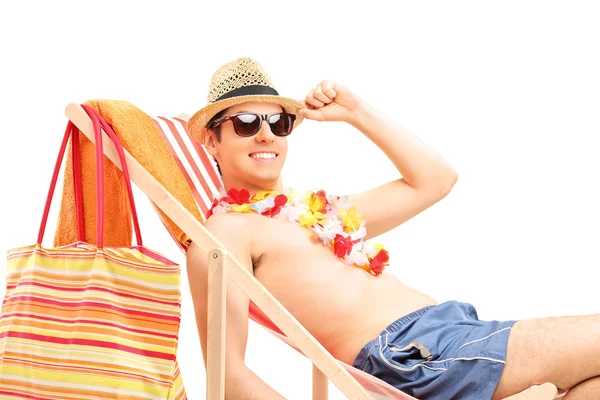 Man sitting on sun lounger — Stock Photo, Image