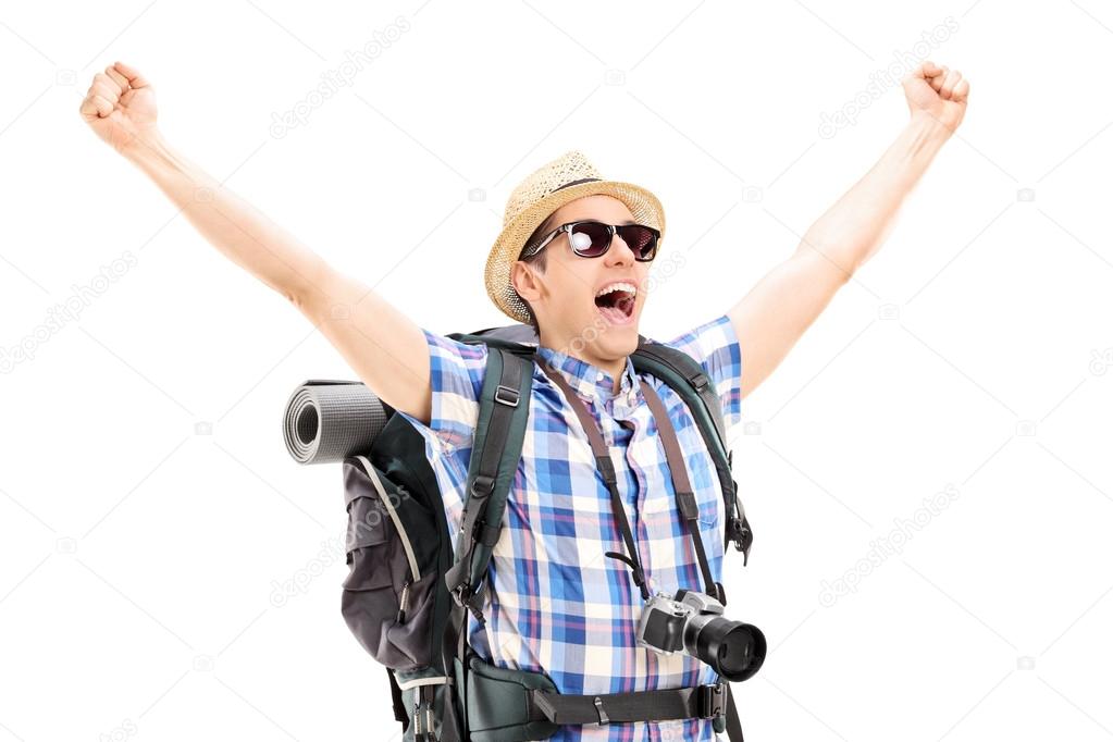 Male hiker with raised hands