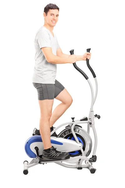 Man on cross trainer machine — Stock Photo, Image