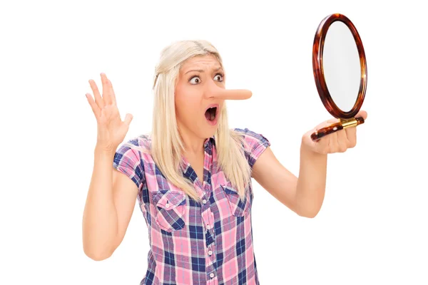 Woman looking at her nose — Stock Photo, Image