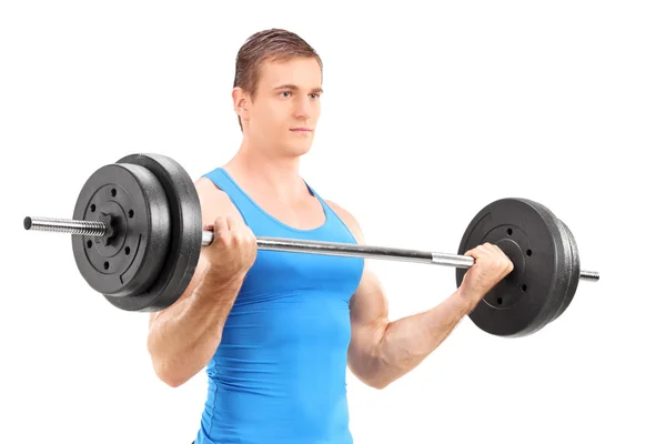 Muscular bodybuilder lifting barbell — Stock Photo, Image