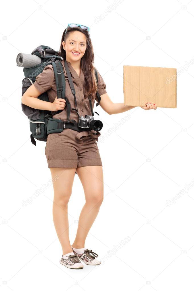 Female hiker holding blank cardboard sign