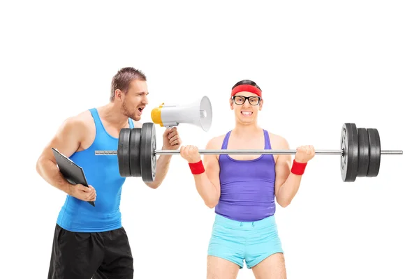 Nerdy guy exercising with coach — Stock Photo, Image