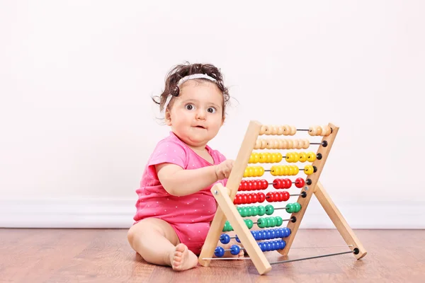 Little girl playing with abacus — Stock Photo, Image