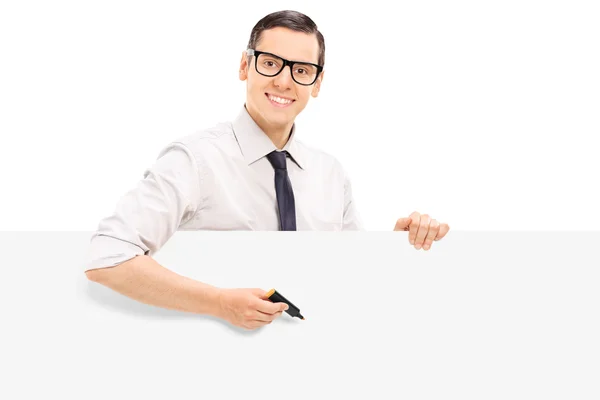 Man holding marker against panel — Stock Photo, Image