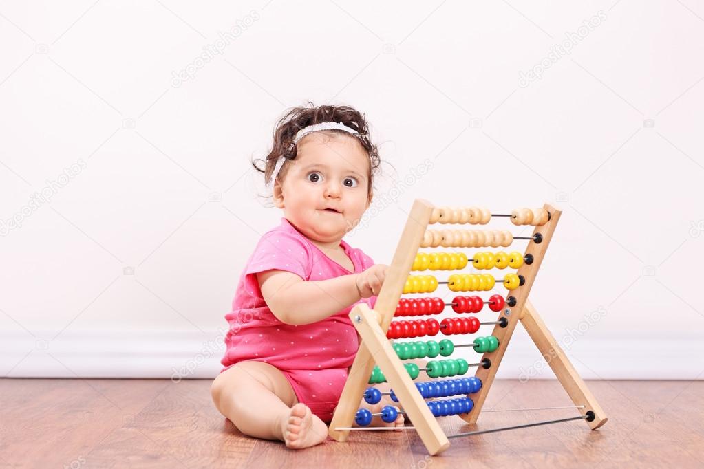 Little girl playing with abacus