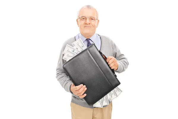 Senior holding briefcase full of cash — Stock Photo, Image