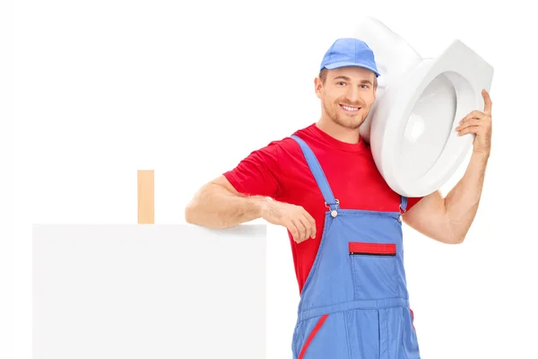 Male plumber standing by signboard — Stock Photo, Image